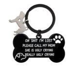 Black stainless steel dog keychain in the shape of a bone with a phrase engraved on it. Includes an additional natural stainless steel dog keychain on the keyring.